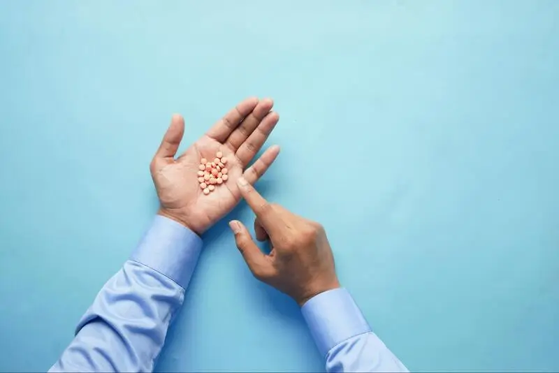 Man counting the pills in his hand
