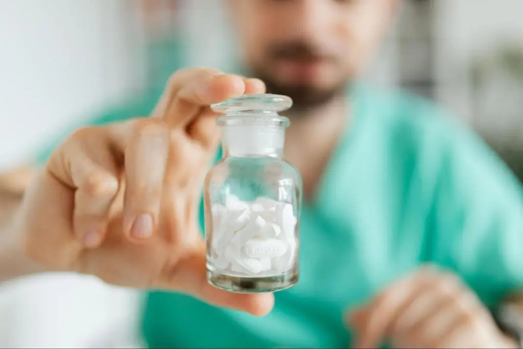 man holding a bottle of pills
