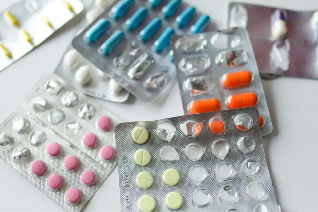 different types of pills on a white surface