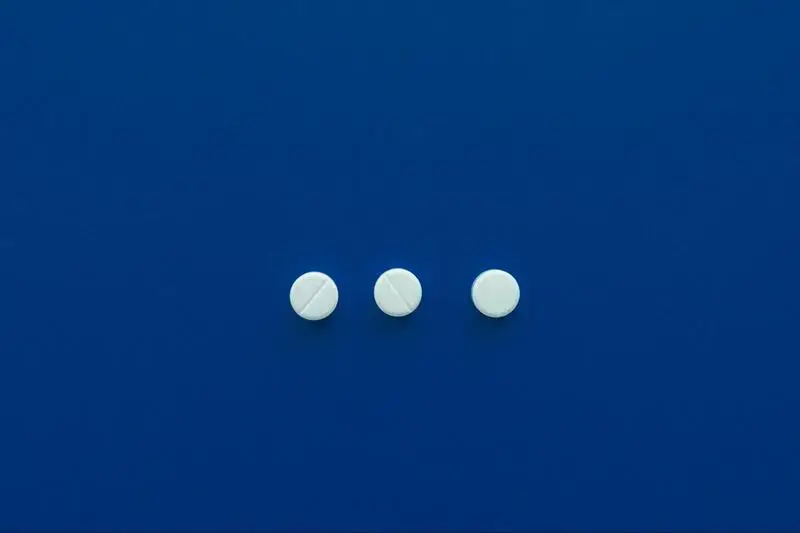 3 while pills on a deep blue background