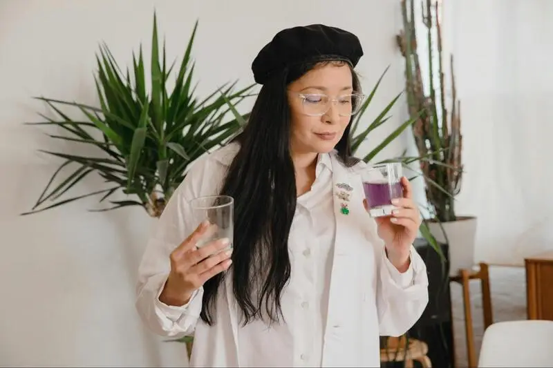Woman holding a beverage containing codeine cough syrup with soda and hard candy