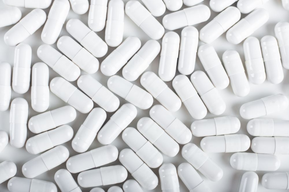 Gabapentin capsules spread across a white background